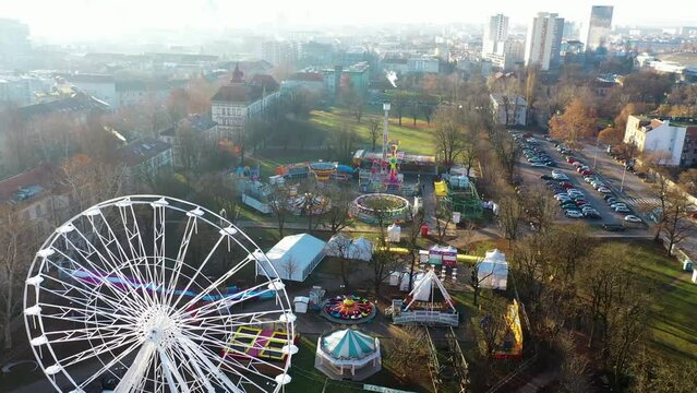 Aerial view of a theme park with Ferris wheel at Trg Franje Tudjmana park at sunset in Zagreb downtown, Croatia.
