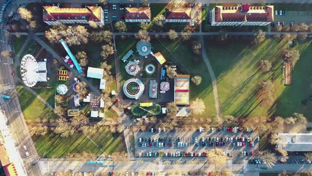 Aerial view of a theme park with Ferris wheel at Trg Franje Tudjmana park at sunset in Zagreb downtown, Croatia.