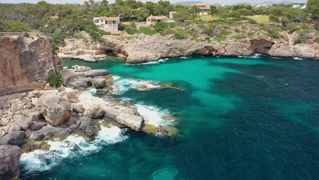Aerial view of S'Almonia beach, a bay with rugged cliffs, Cala Ignacio Laino, Balearic Islands, Spain.