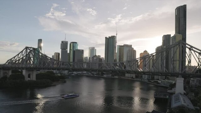 a summer sunset shot of the city of brisbane and story bridge from wilson reserve in queensland, australia
