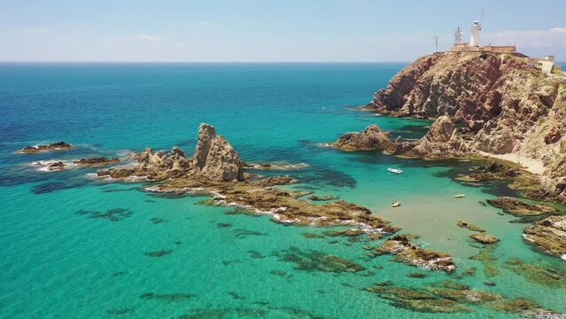 Aerial view of Faro de Cabo de Gata, a lighthouse along the wild coastline with cliffs, Almeria, Spain.