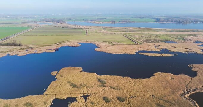 Aerial view of reed swamp and lake, flying sidewards in nature reserve Tetjehorn, 't Roegwold, province of Groningen, The Netherlands.