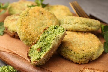 Delicious cutlets with broccoli and parsley on wooden board, closeup. Vegan dish