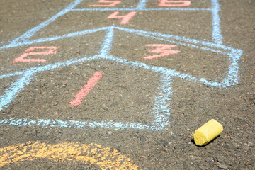 Fototapeta Hopscotch drawn with colorful chalk on asphalt outdoors, closeup obraz