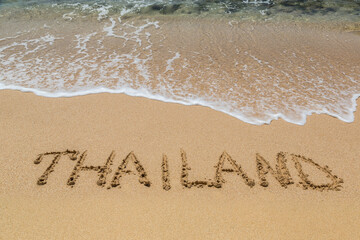 Thailand written in a sandy