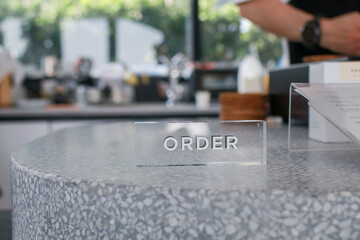 Order here Sign on counter in coffee shop. Industry food, Cafe and restaurant idea concept. Business text