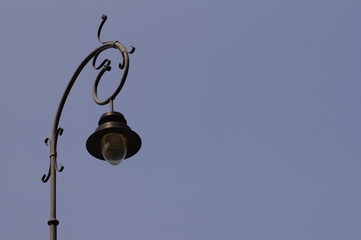 Street lamp against blue sky, photo with space for quote or title. - obrazy, fototapety, plakaty