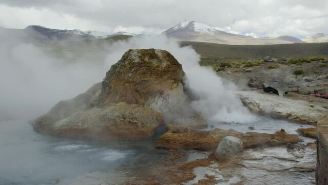 Closeup of Large Rock Covered by Steam and Hot Acidic Water, El Tatio Geyser, Chile.