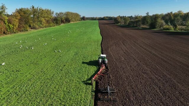Aerial view of a tractor ploughing at a farm in Brandenburg, Germany.