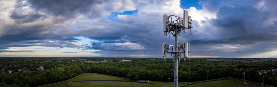 Drone view of telecommunication equipment on top of tall repeater tower located on the outskirts of midwest American city of Lexington, Kentucky