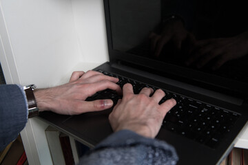 Young Man Hand Working on a Laptop