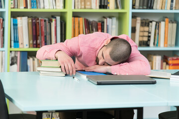 Tired Student Sleeping In Library