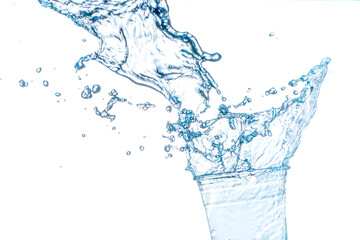 Drinking water splashing from the glass on white background