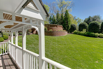 Spring Day on Front Porch of Playhouse with Fresh Cut Lawn and Curved Brick Wall