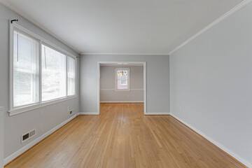 Fototapeta na wymiar Empty Modern Living Room Interior with Hardwood Floors and Grey Walls