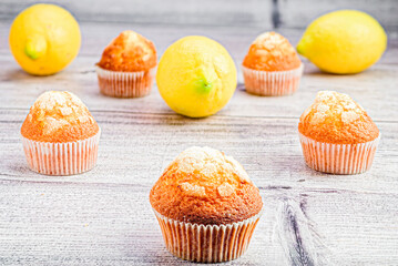 Contrast of flavors: muffins surrounded by fresh lemons