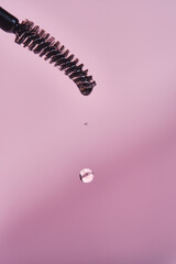 Cosmetic oil for the growth of eyebrows and eyelashes with a brush.