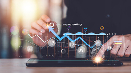 Marketer showing SEO concept ,analysis of market data graphs and charts ,Optimization Analyzer ,website search engine ranking social media according to the results analysis data ,online marketing