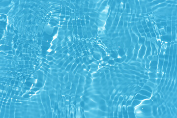 Blue water with ripples on the surface. Defocus blurred transparent blue colored clear calm water...