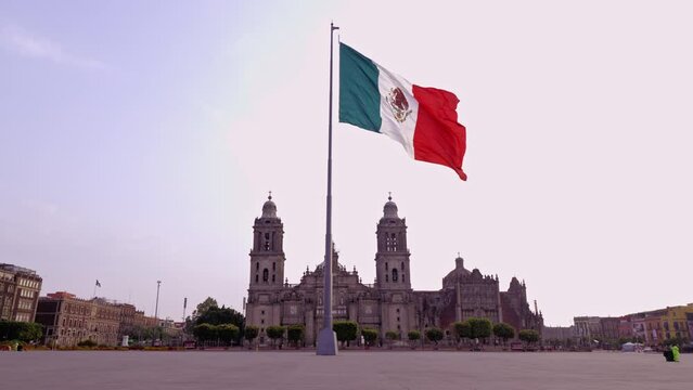 Flag of mexico waving with the metropolitan cathedral in the background, Mexico City downtown. 4k video