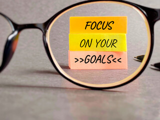 Inspirational and motivational quote. Focus on your goals. Text written on notepaper background.