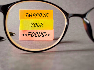 Inspirational and motivational quote. Improve your focus. Text written on notepaper background.