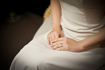 Fototapeta na wymiar Hands of the bride sitting with her hands together in the bridal waiting room