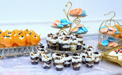 A table with sweets, lollipops. The concept of celebration. Fancy desserts. cake, meringue roll