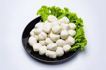 Fish balls ready to be served in a white container.