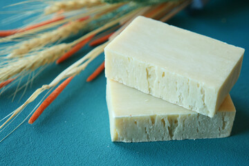 Homemade natural soap bar and dry flower on black background 