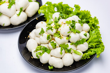 Fish balls ready to be served in a white container.