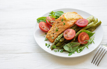 Baked Delicious salmon, green asparagus on  plate
