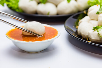 Fish balls ready to be served in a white container.