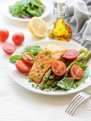 Baked Delicious salmon, green asparagus on  plate