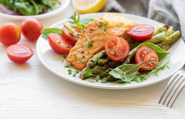Baked Delicious salmon, green asparagus on  plate