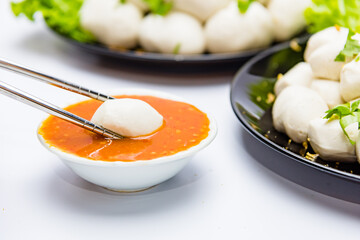 Fish balls ready to be served in a white container.