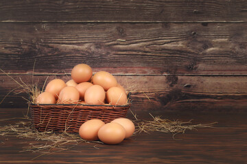 Fresh eggs in a basket beautifully placed on the wooden floor.