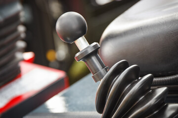 Gear shift lever in tractor, excavator or other industrial machine. Transportation