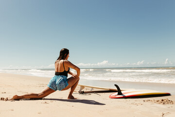 Fototapeta na wymiar woman with surfboard on beach