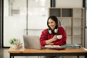 Asian business woman Working at the office, use notebook, smart phone