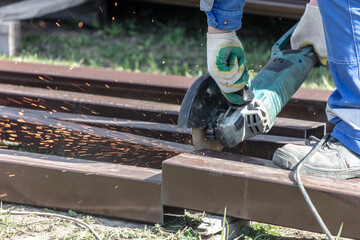 Cutting metal with a grinder. Sparks fly out of the grinder