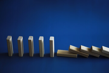 Closeup thick domino wood block in a row stop the falling, be stable in crisis, business solution...