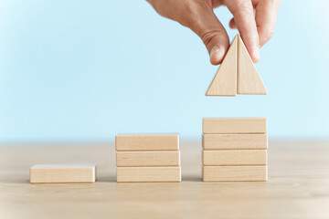 Growth, target, upskill concept. Growth of wooden cubes on a clean background. Business, economics, strategy idea