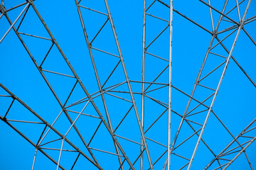 A fragment of a metal structure of a park attraction on a summer day