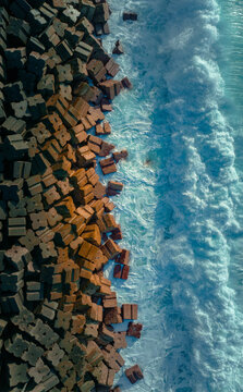 Mediterranean Majesty: Aerial View of Ocean Waves Crashing Against Wavebreaker