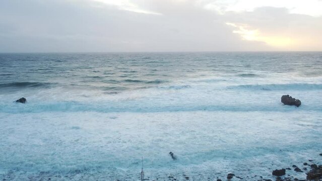 Rustic shipwreck part on ocean coastline with endless horizon, aerial view