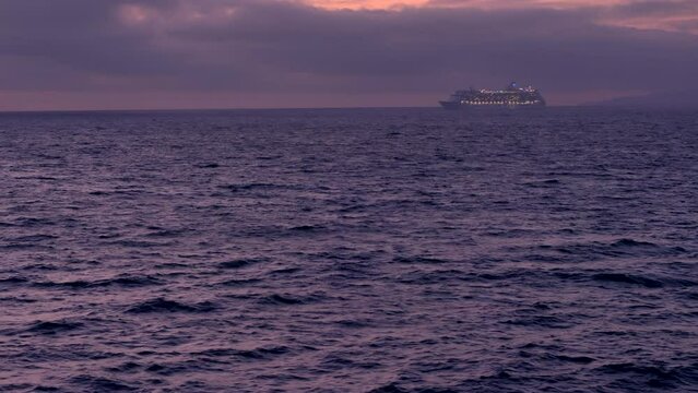 Cruise ship in distance - sailing. Smooth sea.