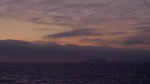 Cruise ship in distance - calm sea - golden hour