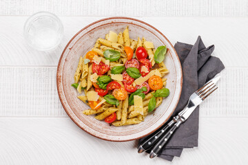 Italian pasta adorned with fresh tomatoes and aromatic basil