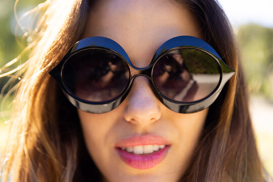 Close-up portrait of attractive biracial young woman wearing sunglasses